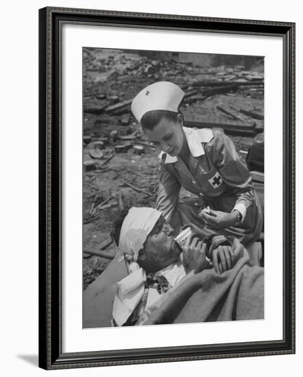 The Red Cross Nurse Trying to Help the Injured Man Eat and Drink-Allan Grant-Framed Photographic Print