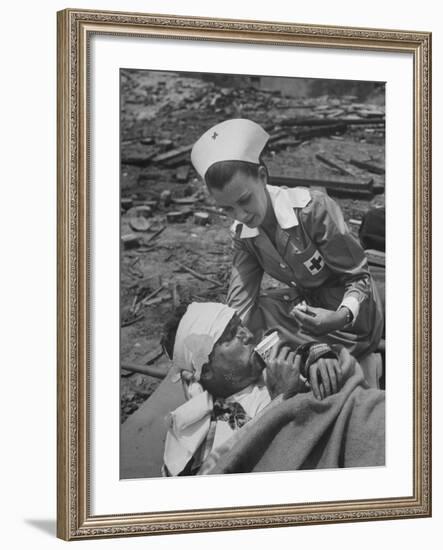 The Red Cross Nurse Trying to Help the Injured Man Eat and Drink-Allan Grant-Framed Photographic Print