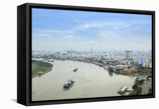 The skyline of Ho Chi Minh City (Saigon) showing the Bitexco tower and the Saigon River, Ho Chi Min-Alex Robinson-Framed Premier Image Canvas