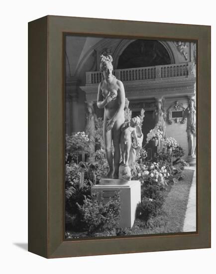 The Statue of Aphrodite and Eros in Louvre Museum During a Flower Show-Dmitri Kessel-Framed Premier Image Canvas