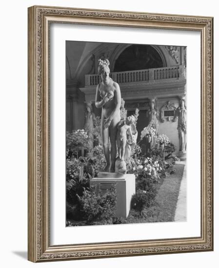 The Statue of Aphrodite and Eros in Louvre Museum During a Flower Show-Dmitri Kessel-Framed Photographic Print