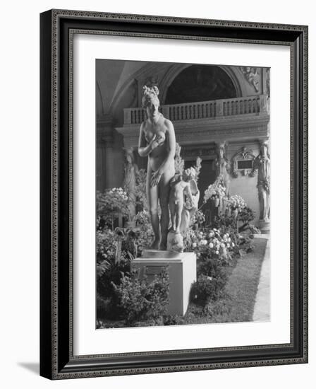 The Statue of Aphrodite and Eros in Louvre Museum During a Flower Show-Dmitri Kessel-Framed Photographic Print