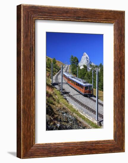 The Swiss Bahn Train Runs on its Route with the Matterhorn in the Background, Switzerland-Roberto Moiola-Framed Photographic Print