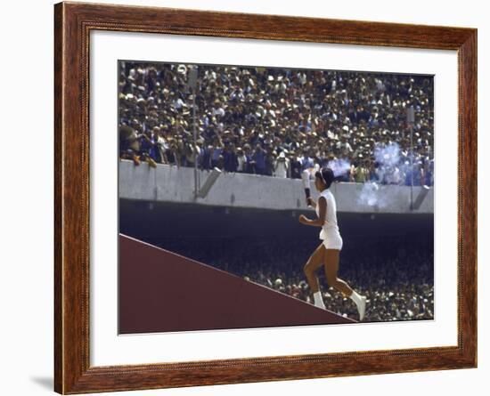 The Torch Being Carried Up the Steps in the Olympic Stadium at the Summer Olympics-John Dominis-Framed Photographic Print