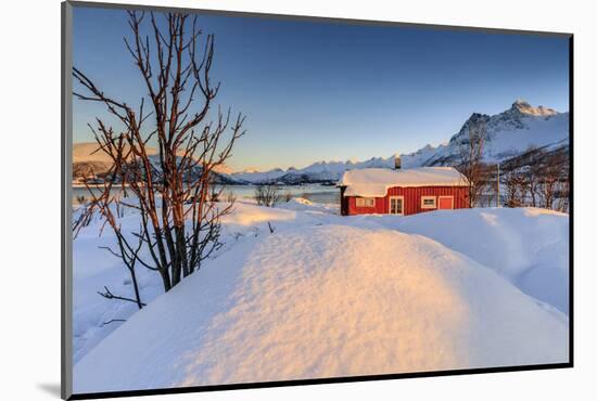 The Winter Sun Illuminates a Typical Norwegian Red House Surrounded by Fresh Snow-Roberto Moiola-Mounted Photographic Print