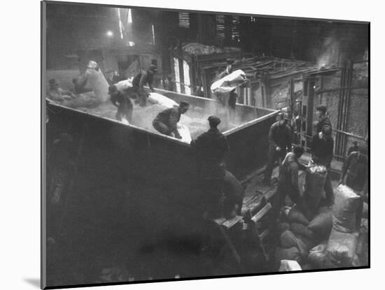 The Workmen Quickly Covering the Ingot with Vermiculite-Ralph Morse-Mounted Photographic Print