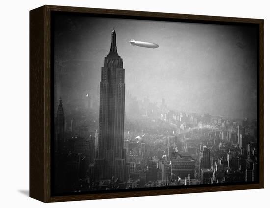 The Zeppelin Hindenburg Floats Past the Empire State Building-null-Framed Premier Image Canvas