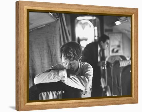 Thoughtful Senator Robert F. Kennedy on Airplane During Campaign Trip to Aid Local Candidates-Bill Eppridge-Framed Premier Image Canvas