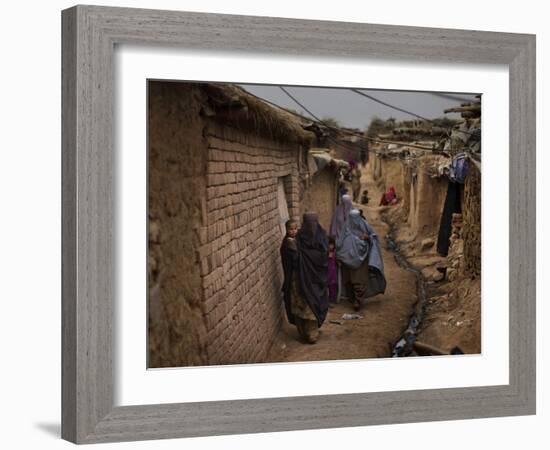 Three Afghan Refugee Women and their Children Walk in an Alley of a Poor Neighborhood in Pakistan-null-Framed Photographic Print