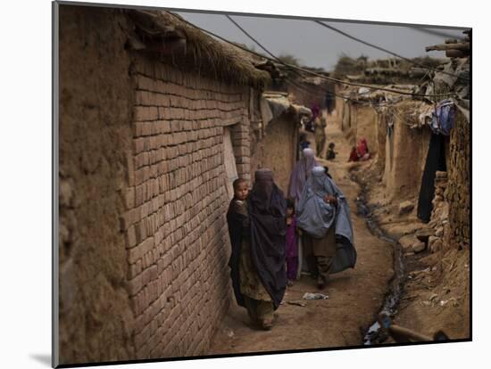 Three Afghan Refugee Women and their Children Walk in an Alley of a Poor Neighborhood in Pakistan-null-Mounted Photographic Print