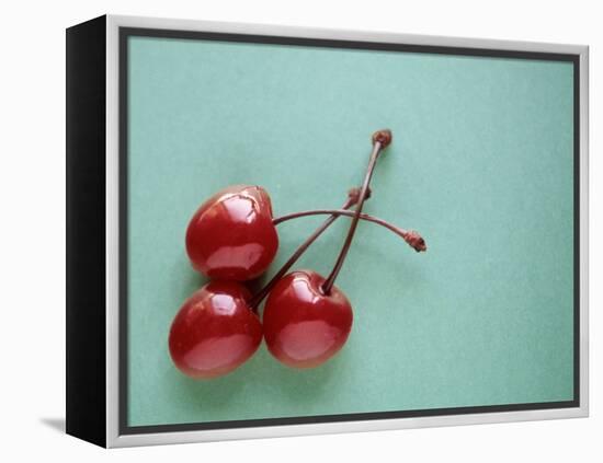 Three Cherries on a Green Background-Karen M^ Romanko-Framed Premier Image Canvas