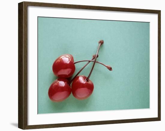 Three Cherries on a Green Background-Karen M^ Romanko-Framed Photographic Print