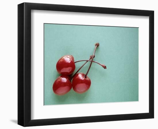 Three Cherries on a Green Background-Karen M^ Romanko-Framed Photographic Print