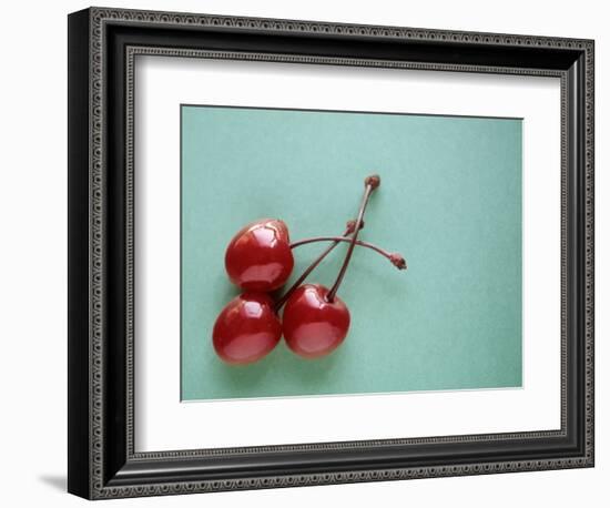 Three Cherries on a Green Background-Karen M^ Romanko-Framed Photographic Print