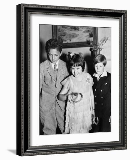 Three Children Standing Together Playing a Game-null-Framed Photo