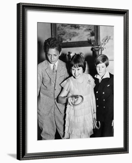 Three Children Standing Together Playing a Game-null-Framed Photo