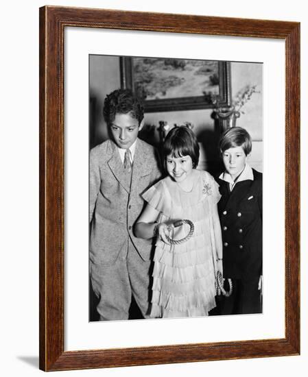 Three Children Standing Together Playing a Game-null-Framed Photo