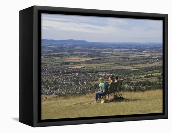 Three Girls Sitting on Bench Looking at View Over Bishops Cleeve Village, the Cotswolds, England-David Hughes-Framed Premier Image Canvas