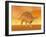Three Kentrosaurus Dinosaurs in the Desert with Hazy Sunset Light-null-Framed Art Print