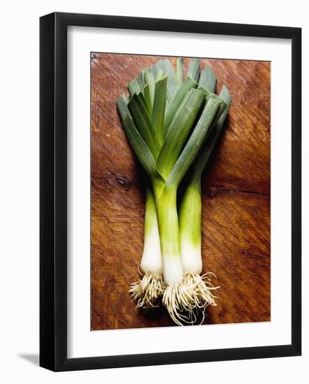 Three Leeks on Wooden Background-null-Framed Photographic Print