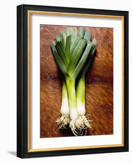 Three Leeks on Wooden Background-null-Framed Photographic Print