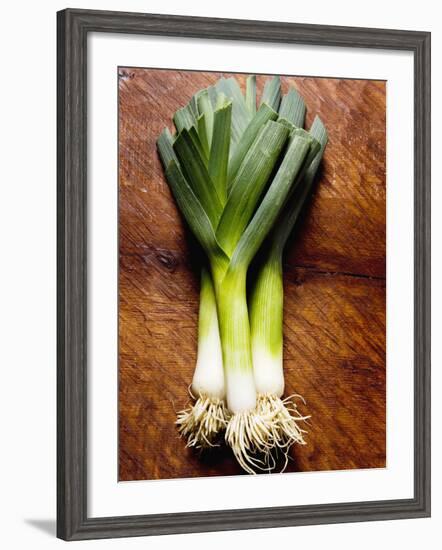 Three Leeks on Wooden Background-null-Framed Photographic Print