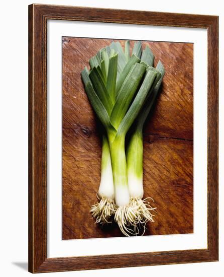 Three Leeks on Wooden Background-null-Framed Photographic Print