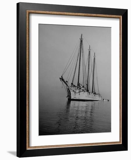 Three-Masted Schooner, Sails Furled, on the Water with a Dinghy in Tow-Bernard Hoffman-Framed Photographic Print