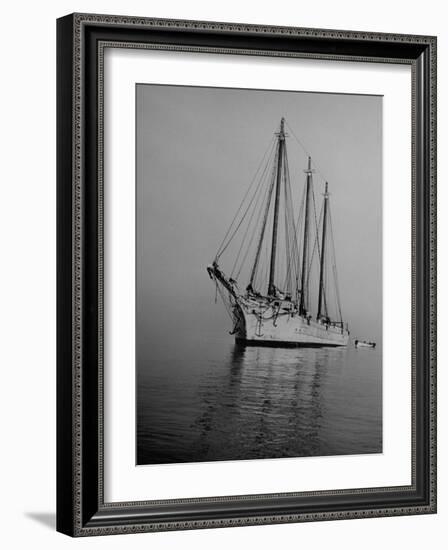 Three-Masted Schooner, Sails Furled, on the Water with a Dinghy in Tow-Bernard Hoffman-Framed Photographic Print