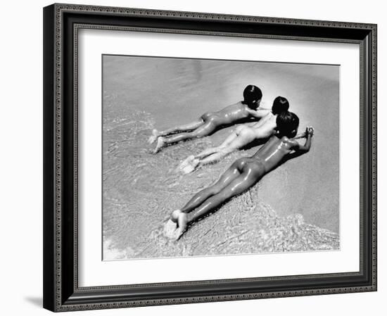 Three Native Boys Sunbathing Nude at the Edge of the Surf at Ocean Beach-Howard Sochurek-Framed Photographic Print