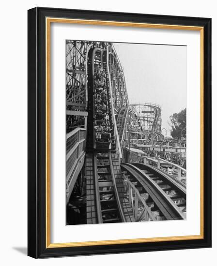 Thrill Seekers Getting a Hair Raising Ride on Cyclone Roller Coaster at Coney Island Amusement Park-Marie Hansen-Framed Photographic Print