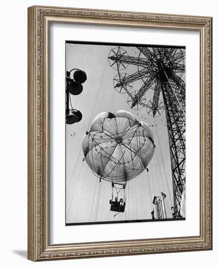 Thrillseeking Couple Take a Ride on the 300-Ft. Parachute Jump at Coney Island Amusement Park-null-Framed Photographic Print