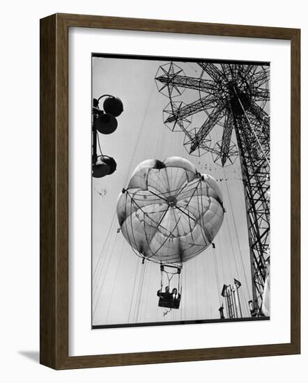 Thrillseeking Couple Take a Ride on the 300-Ft. Parachute Jump at Coney Island Amusement Park-null-Framed Photographic Print