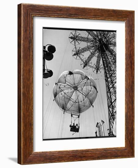 Thrillseeking Couple Take a Ride on the 300-Ft. Parachute Jump at Coney Island Amusement Park-null-Framed Photographic Print