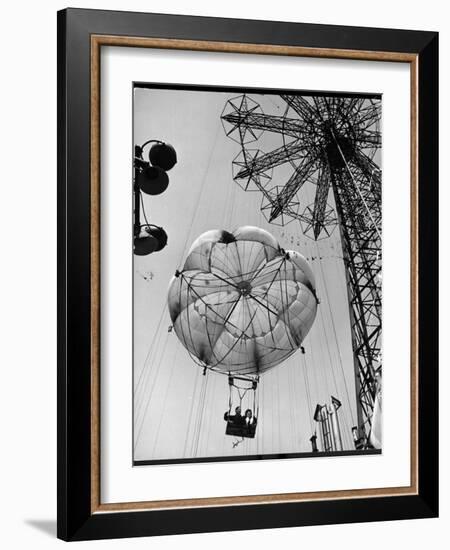 Thrillseeking Couple Take a Ride on the 300-Ft. Parachute Jump at Coney Island Amusement Park-null-Framed Photographic Print