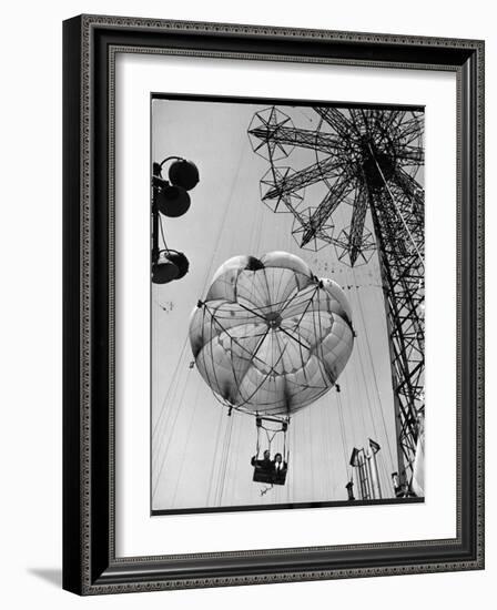 Thrillseeking Couple Take a Ride on the 300-Ft. Parachute Jump at Coney Island Amusement Park-null-Framed Photographic Print