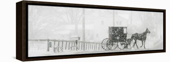 Through a Driving Snow Storm, an Amish Buggy Travels Along a Road in Parkman, Ohio-null-Framed Premier Image Canvas