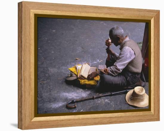 Tibetan Buddhist Pilgrim Reading Texts and Holding Prayer Wheel, Lhasa, China-Alison Wright-Framed Premier Image Canvas