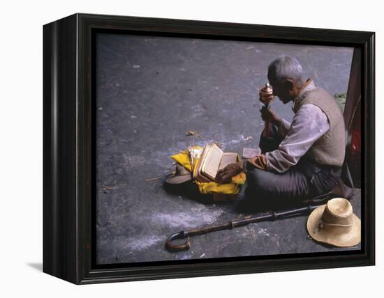 Tibetan Buddhist Pilgrim Reading Texts and Holding Prayer Wheel, Lhasa, China-Alison Wright-Framed Premier Image Canvas