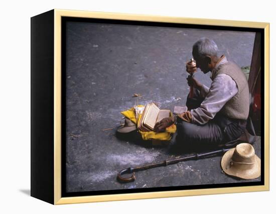 Tibetan Buddhist Pilgrim Reading Texts and Holding Prayer Wheel, Lhasa, China-Alison Wright-Framed Premier Image Canvas