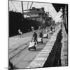 Tin Ingots Being Stacked Along the Penang Docks-Carl Mydans-Mounted Premium Photographic Print