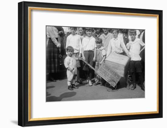 Toddler Holds a Small Soap Box Derby Vehicle-null-Framed Art Print