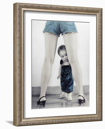 Toddler Standing Behind Woman's Legs Looking Through-Nora Hernandez-Framed Giclee Print