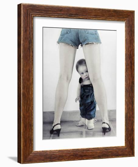 Toddler Standing Behind Woman's Legs Looking Through-Nora Hernandez-Framed Giclee Print