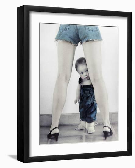 Toddler Standing Behind Woman's Legs Looking Through-Nora Hernandez-Framed Giclee Print