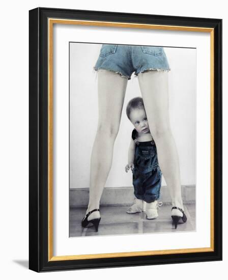 Toddler Standing Behind Woman's Legs Looking Through-Nora Hernandez-Framed Giclee Print