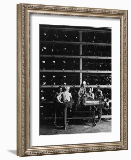 Torpedo Men Relaxing Beneath Rows of Deadly Torpedoes in Torpedo Shop During WWII-Horace Bristol-Framed Photographic Print