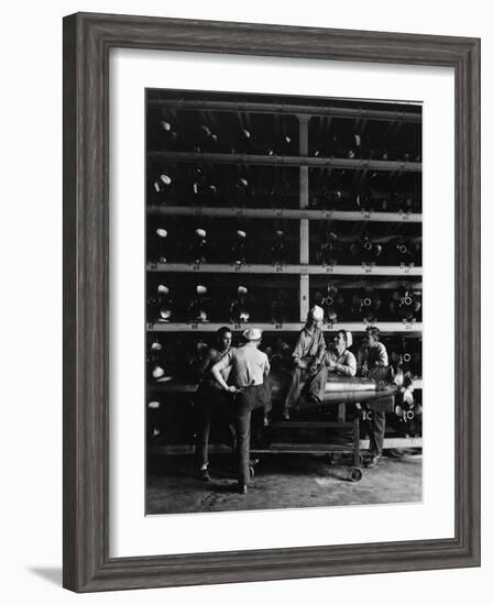 Torpedo Men Relaxing Beneath Rows of Deadly Torpedoes in Torpedo Shop During WWII-Horace Bristol-Framed Photographic Print