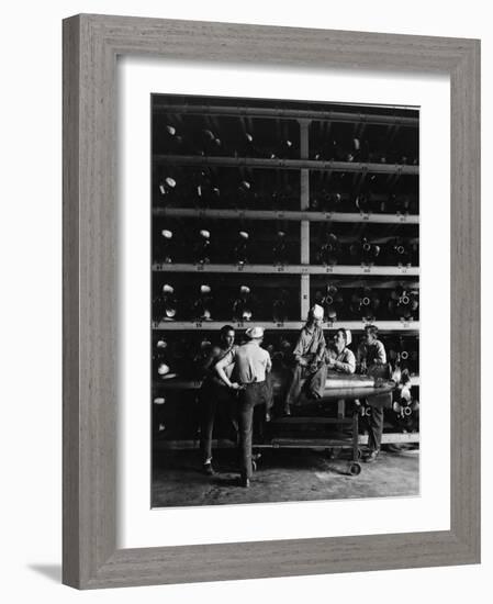 Torpedo Men Relaxing Beneath Rows of Deadly Torpedoes in Torpedo Shop During WWII-Horace Bristol-Framed Photographic Print