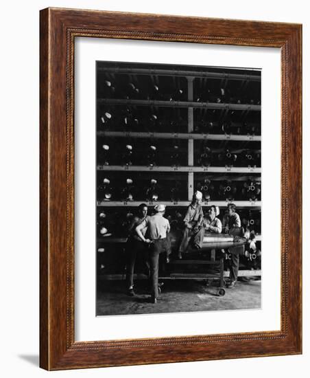 Torpedo Men Relaxing Beneath Rows of Deadly Torpedoes in Torpedo Shop During WWII-Horace Bristol-Framed Photographic Print